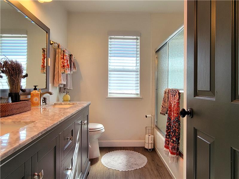The full Main Bath upstairs features new Undermounted Dual Sinks, Solid Surface Counter, Vanity/hardware & Sliding Shower Door!
