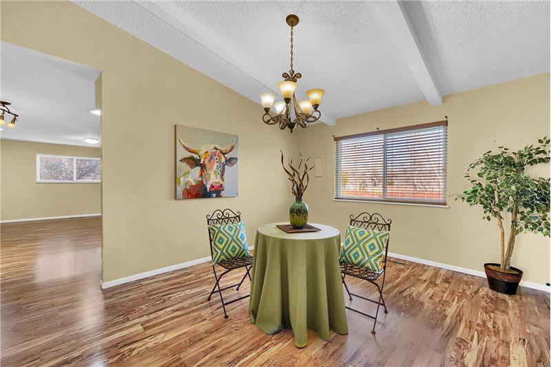 The formal Dining Room is off the Kitchen and has hickory laminate flooring, & beamed ceiling with contemporary light fixture.