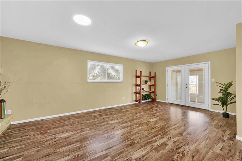 French doors lead into the heated Sunroom.
