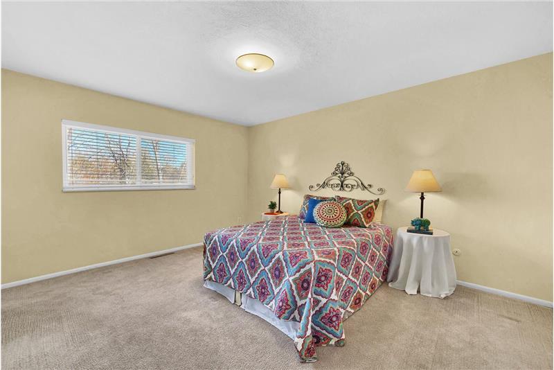 The Master Bedroom features neutral carpet, a closet, and adjoining three quarter shower bathroom.
