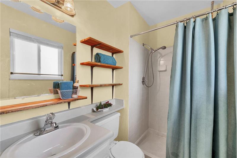 The Master Bathroom has linoleum floors, a vanity, and shower.