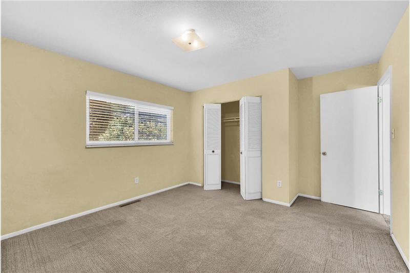 Bedroom #3 has neutral carpets, a closet, and a window for natural light.