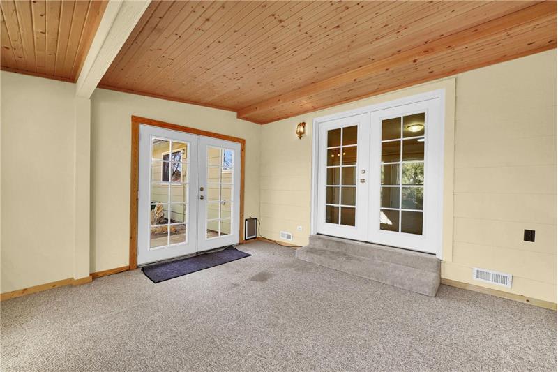 Another view of the Sunroom with French doors into the Family Room and out to the backyard.
