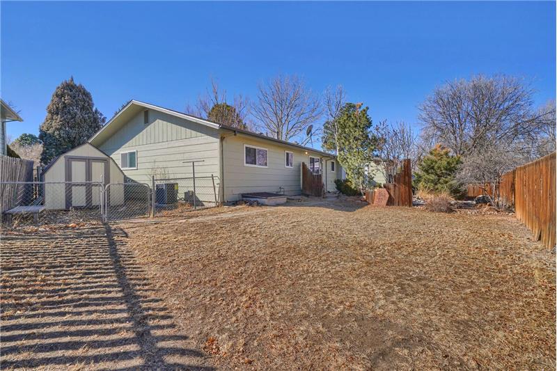 The backyard also features a dog run and storage shed for tools and toys.