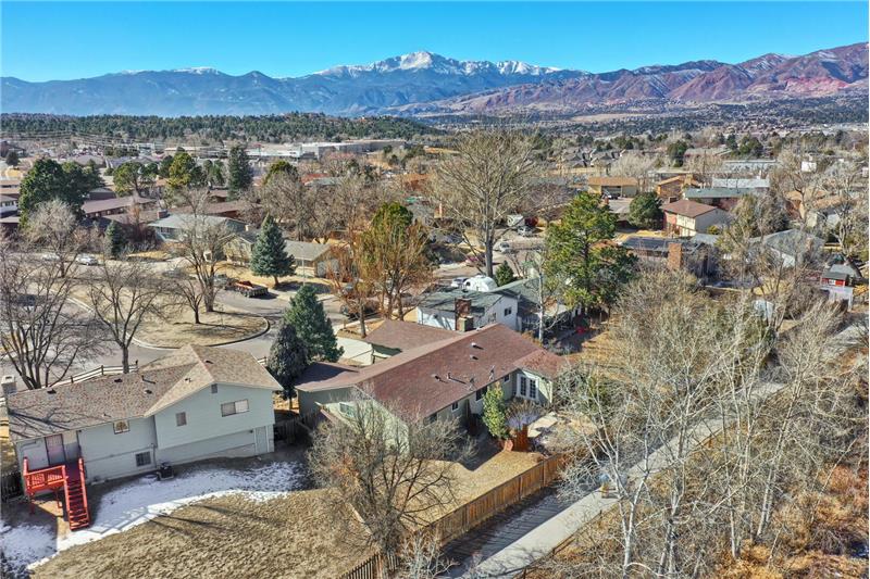 Aerial view of the rear of the home that backs to the Cottonwood Creek and trails.