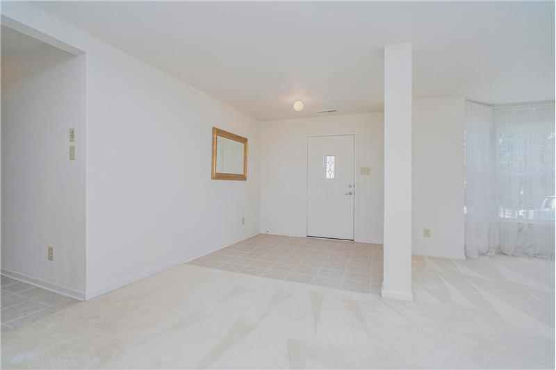 Foyer features ceramic tile flooring and open views to main floor living areas.
