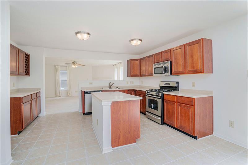 Kitchen has generous storage and counter space, stainless steel appliances, solid surface counters.
