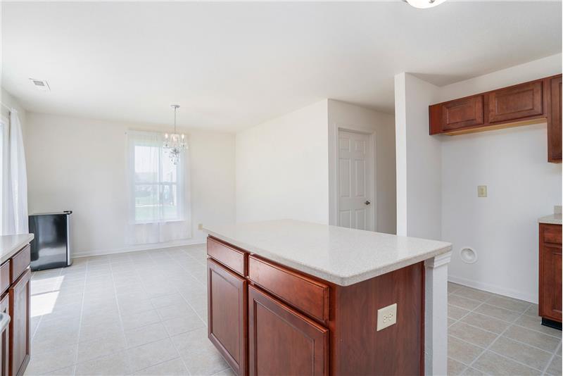 Open sight lines to the breakfast area and to the family room. Adjacent to a large laundry/utility room/pantry.