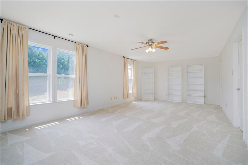 Bright and sunny bonus/recreation room; built-in display shelves/bookcases.