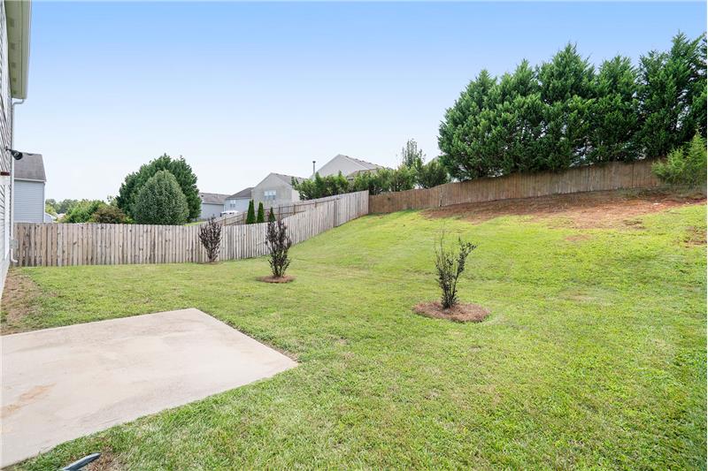 Back yard offers lots of space for play sets and outdoor living.