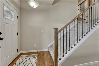 Front wood Entry with iron rails to the upper level.