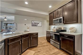 The Kitchen includes a dual stainless steel sink.