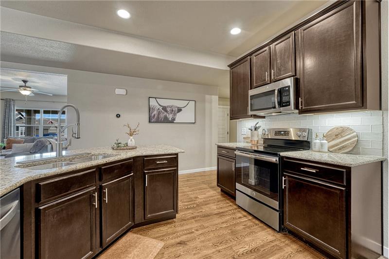 The Kitchen includes a dual stainless steel sink.