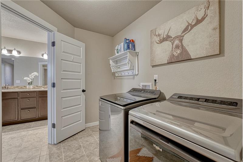 The Primary Bathroom has convenient access to the Laundry Room with washer and dryer that stay.