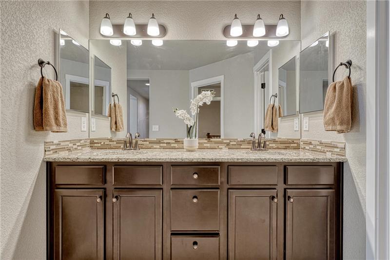 Raised dual sink vanity in the Primary Bathroom.