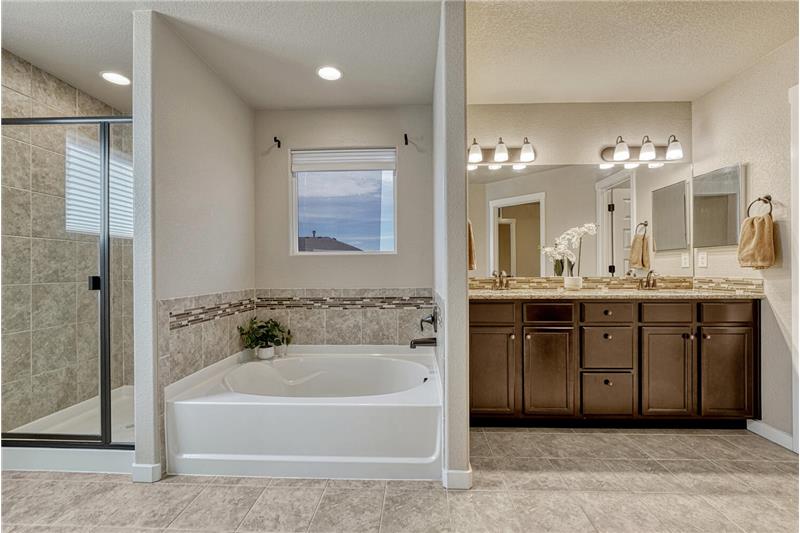 The Primary Bathroom offers a soaking tub and separate tiled shower.
