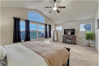 The Primary Suite is large enough for your own private sitting area and has a wall of windows.