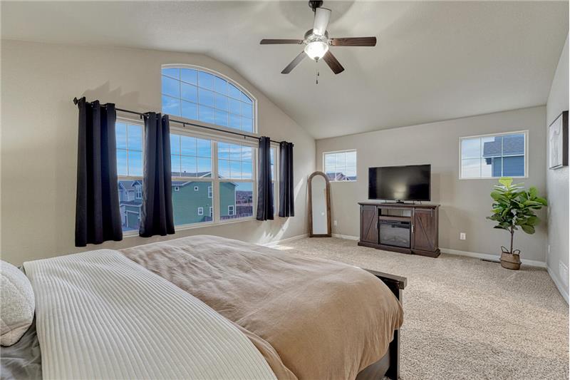 The Primary Suite is large enough for your own private sitting area and has a wall of windows.