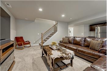 Basement Family Room with neutral carpet and Wet Bar/Kitchenette.