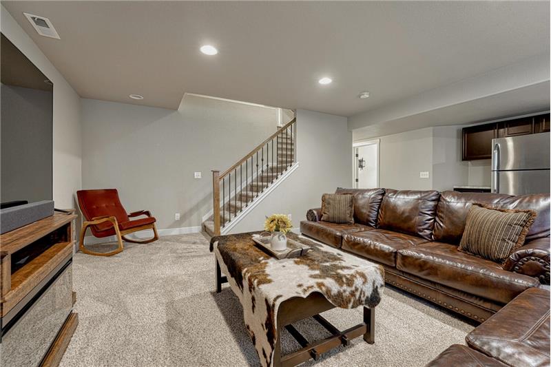 Basement Family Room with neutral carpet and Wet Bar/Kitchenette.