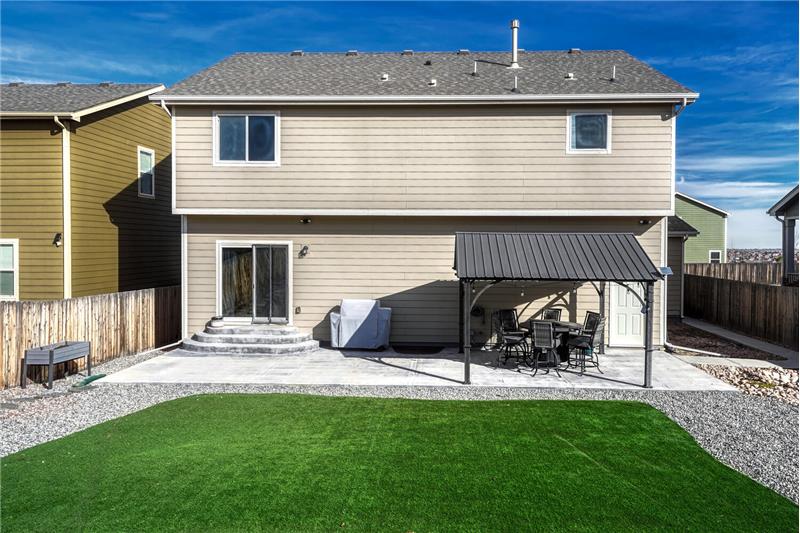 Low maintenance, fenced backyard with expanded patio and gazebo for outdoor relaxation and fun.