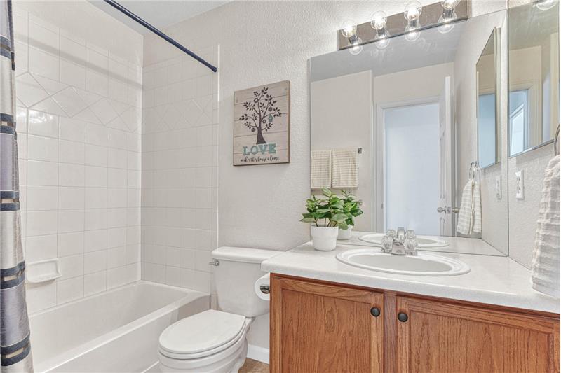 Full bath on upper level with clean white tile surround. Linen closet in upper level hallway also!