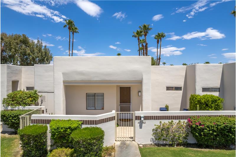 Front with large walled / tiled patio