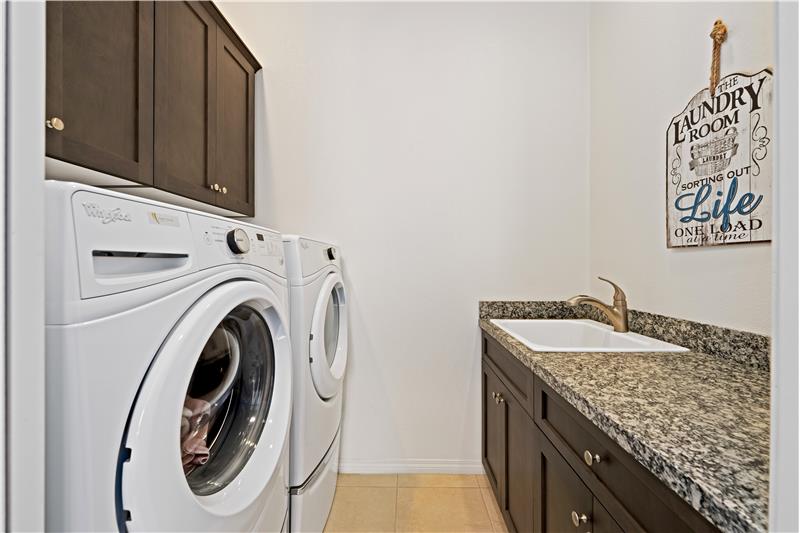 Laundry room with cabinets and sink