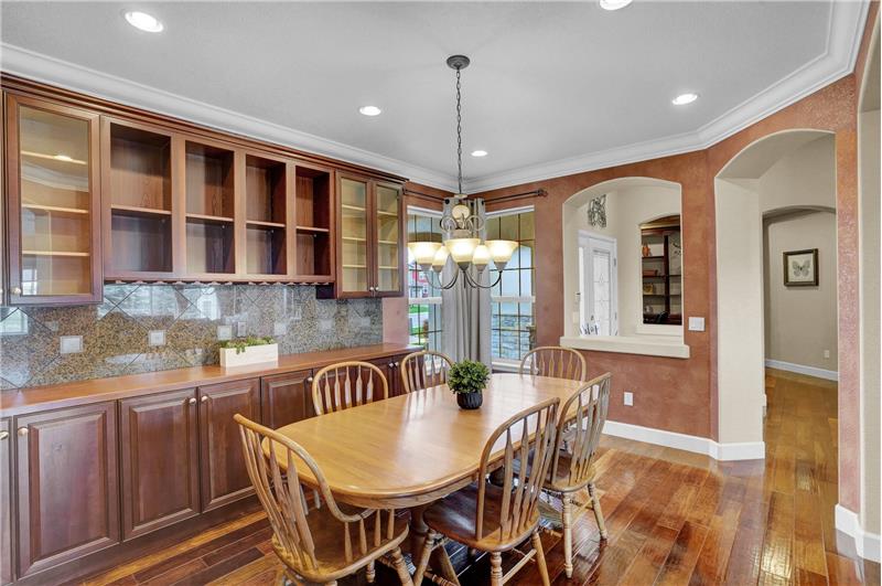 The Formal Dining Rm features crown molding & built-in cabinets & shelves
