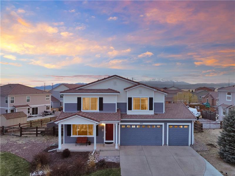 Sunset aerial view of home with gorgeous Pikes Peak views