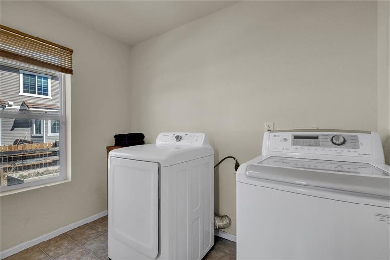 Laundry Room with vinyl floor and window