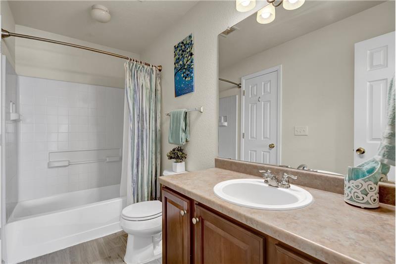 Main Level Full Bathroom with vanity and tub/shower