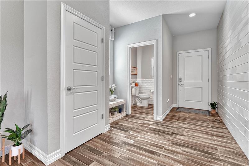 Entry with shiplap accent wall and tile flooring