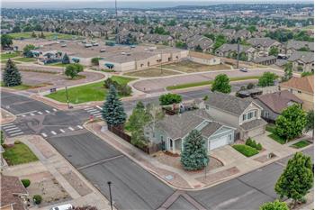 Aerial view of home located on a corner lot that backs to the local elementary school.