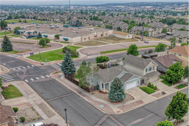 Aerial view of home located on a corner lot that backs to the local elementary school.