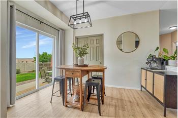 The dining area including a pantry and walk-out access to a large backyard patio.