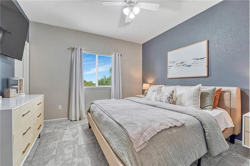 The primary suite provides a peaceful retreat with  walk-in closet, and adjoining bathroom.