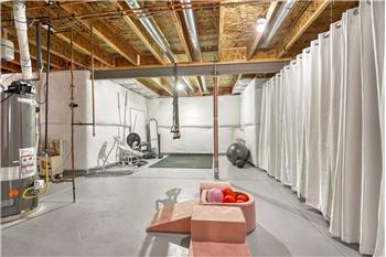 The unfinished basement is ready for expansion with electrical and plumbing already installed for a bathroom.