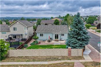Aerial rear view of home and fenced backyard.