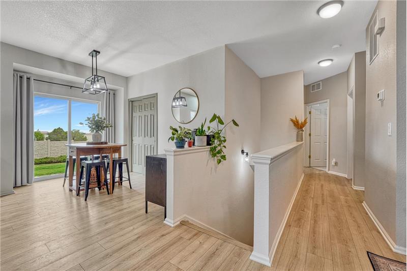 Dining Area with views of stairs to the Unfinished Basement, and hallway to the main level Bedrooms.