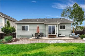 The fenced backyard boasts mature landscaping, lush grass, rock gardens, auto sprinklers, & a spacious patio.