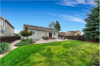 Rear view of home and backyard