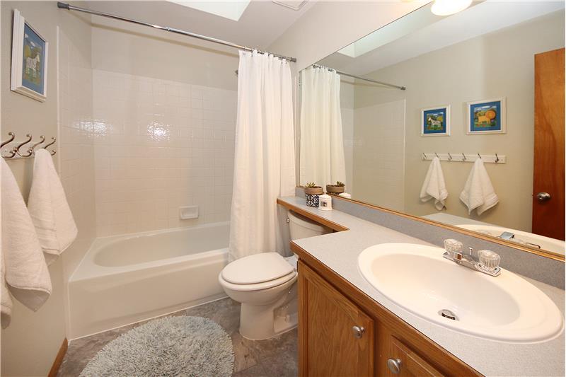 Full bath on upper level with skylight and upgraded flooring
