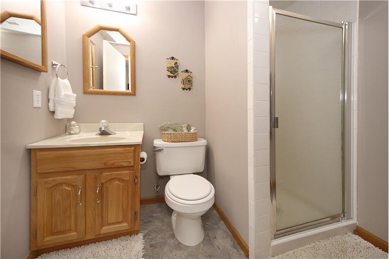 3/4 bath with nice updated flooring and medicine cabinet in basement
