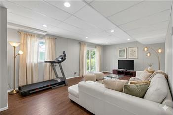 Versatile lower-level recreation space offering endless flexibility for entertaining, work, wellness, or everyday living