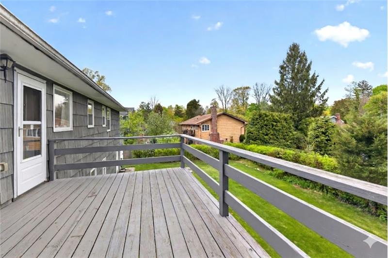 Enjoy summer barbeques on the expanded deck overlooking park- like backyard