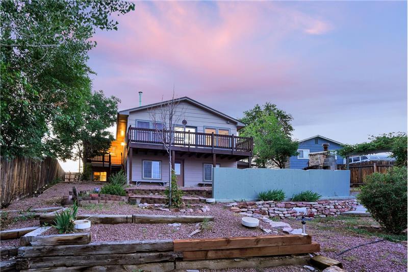 Sunset views of terraced backyard with rock gardens and brick planters