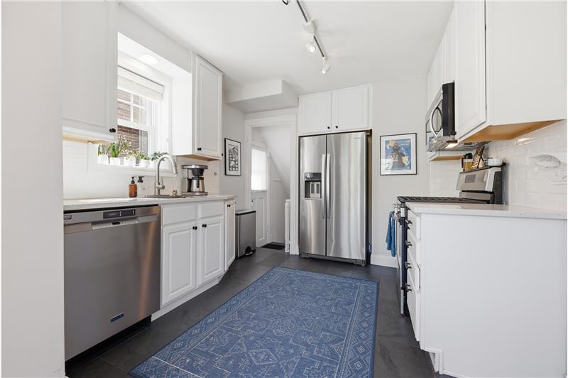 Kitchen with white cabinets and quartz counters