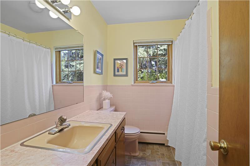 Full bathroom serves the two main-floor guest bedrooms.