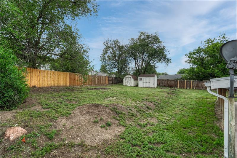 Backyard with two storage sheds